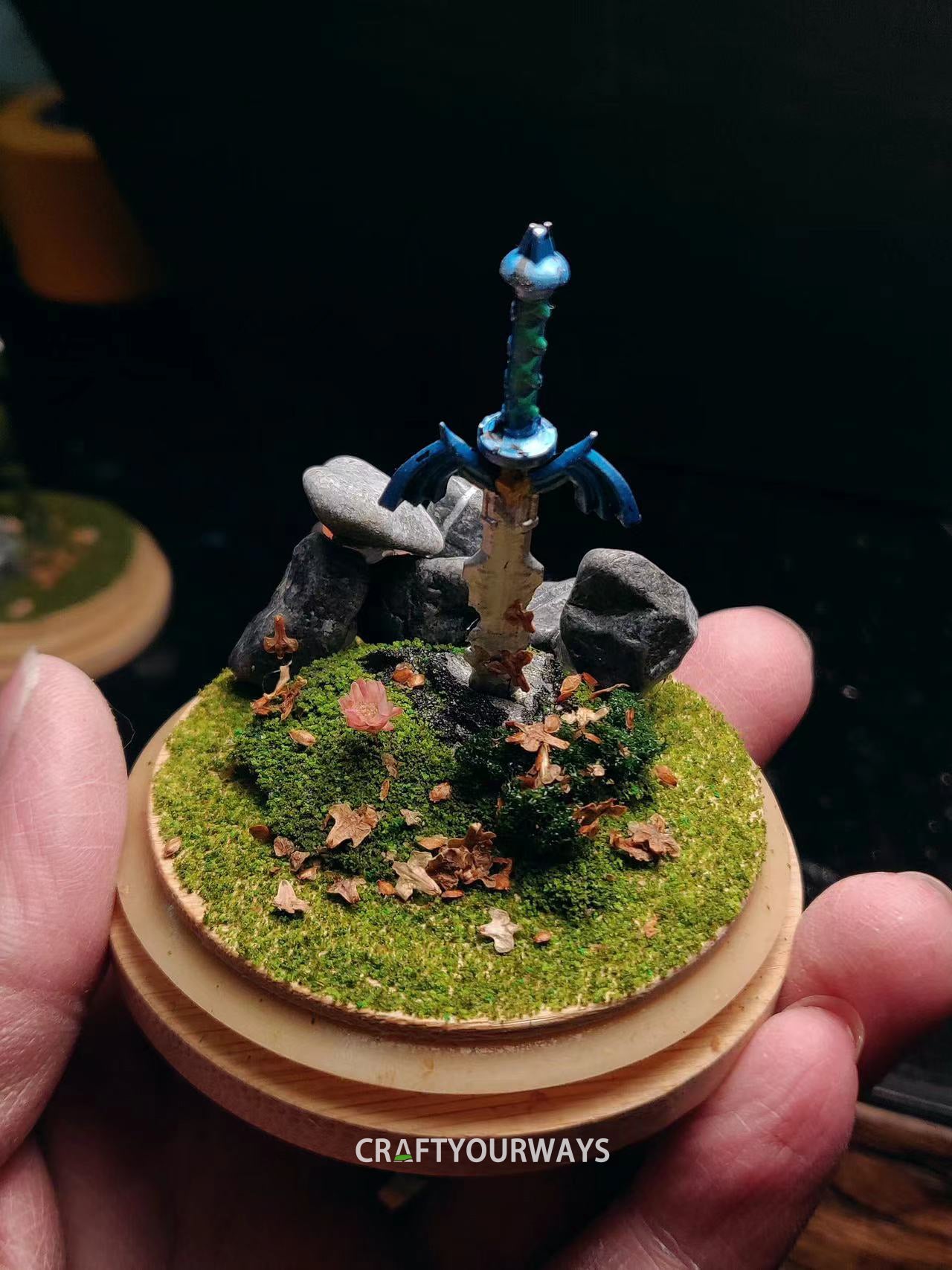 Miniature Scene of a Sword Stuck in Grass