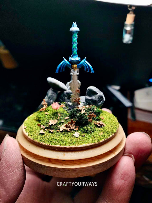 Miniature Scene of a Sword Stuck in Grass