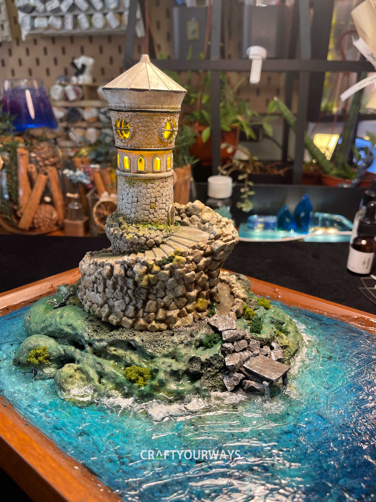 Miniature Stone Lighthouse with Rotating Steps and Illuminated Interior