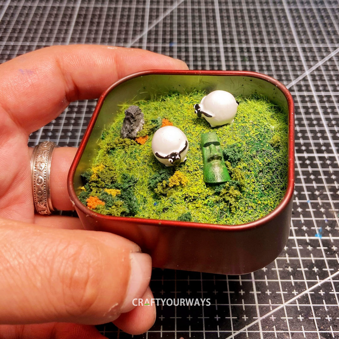 Miniature Resurrected Figure with Grazing Sheep in Tin Box