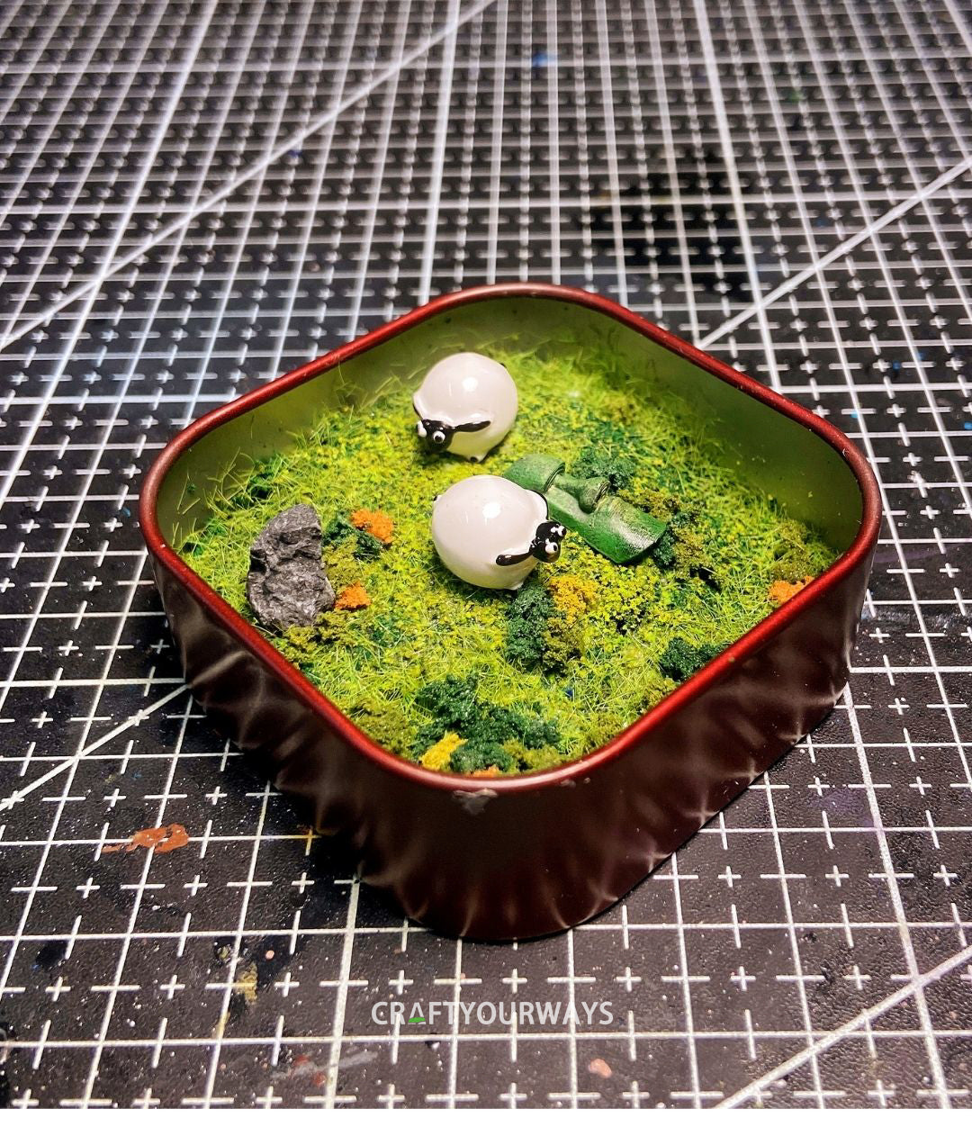 Miniature Resurrected Figure with Grazing Sheep in Tin Box